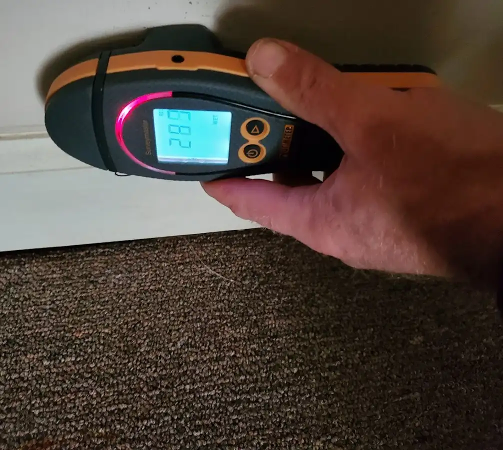 Moisture detection at baseboard during Storm Damage Restoration in Rainsville